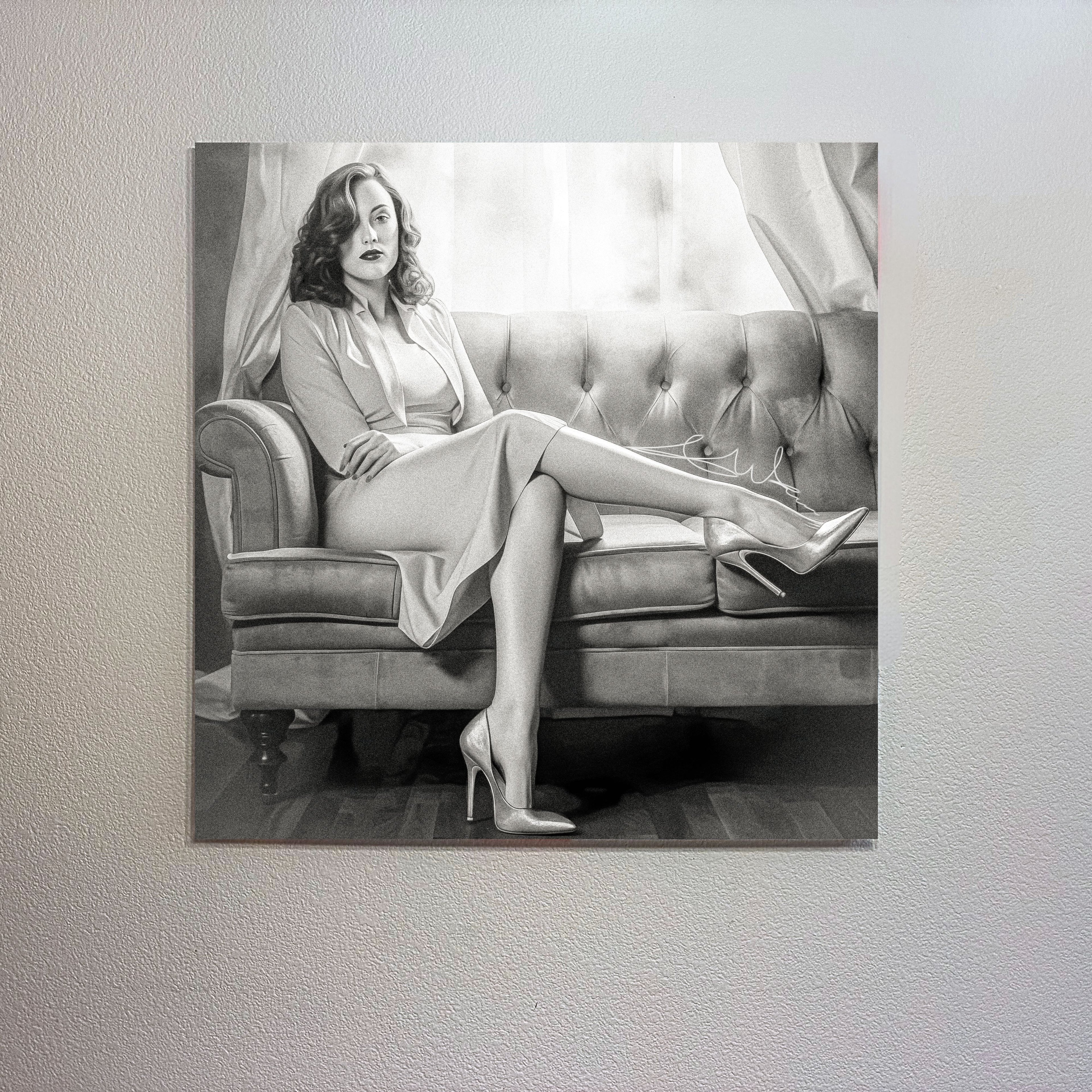 Woman in a dress sitting on a couch with high heels displayed on a wall.