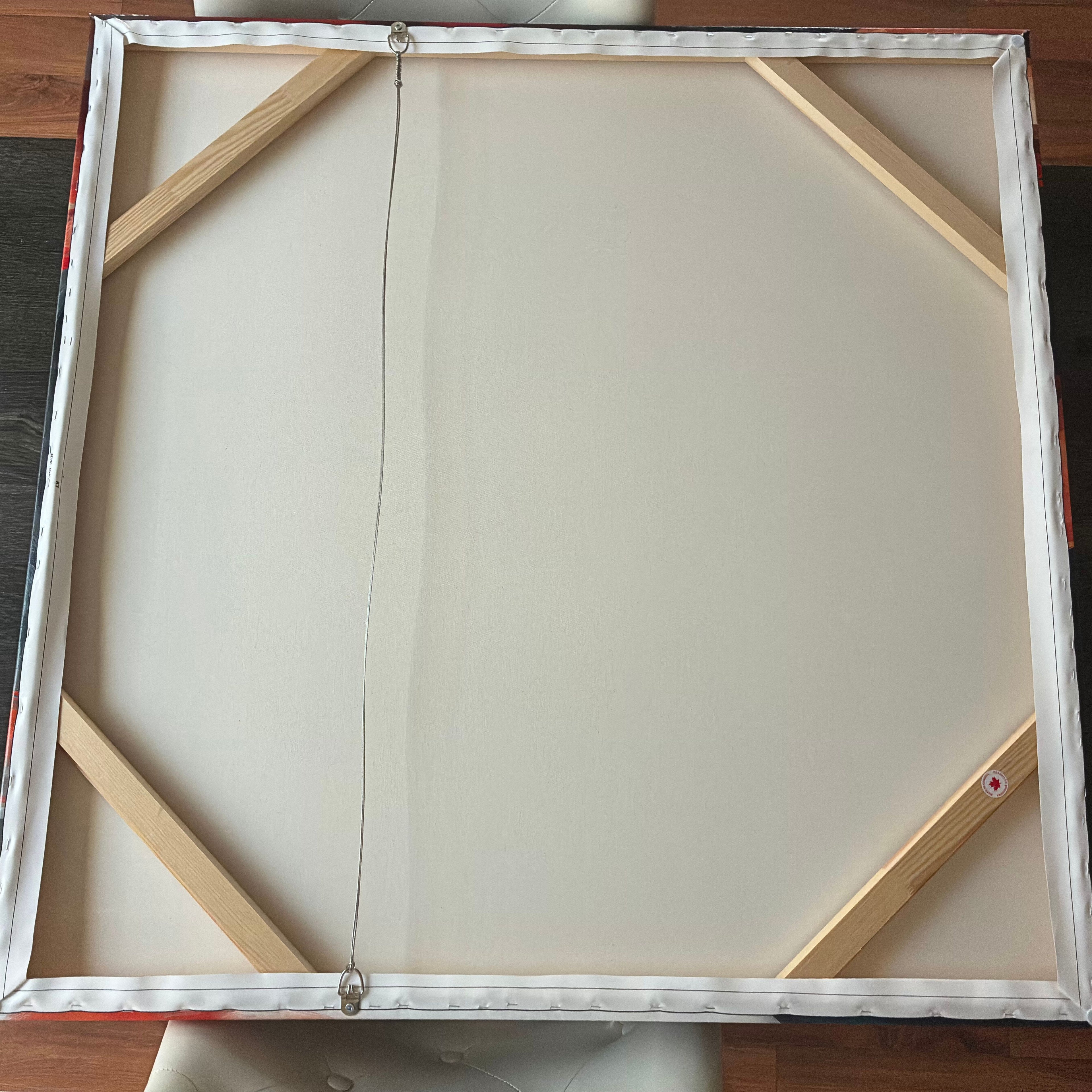 Blank canvas with wooden frame on a wooden surface