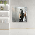 Modern interior with a painting of a woman with long hair on a wall.